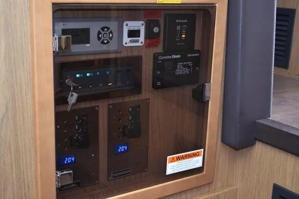 Be Water My Friend Yacht Photos Pics Electrical control panel on 2016 Beneteau GT49 yacht, featuring various switches and displays.