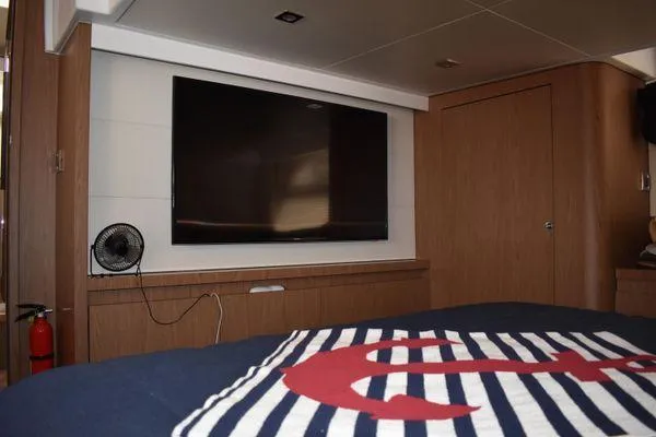 Be Water My Friend Yacht Photos Pics Interior of 2016 Beneteau GT49 yacht with TV, fan, and nautical-themed bedding.
