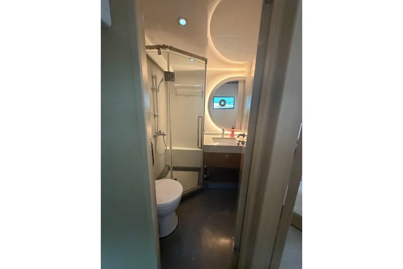  Yacht Photos Pics Modern bathroom in 2025 Haiquan 62 yacht with shower, toilet, and illuminated mirror.