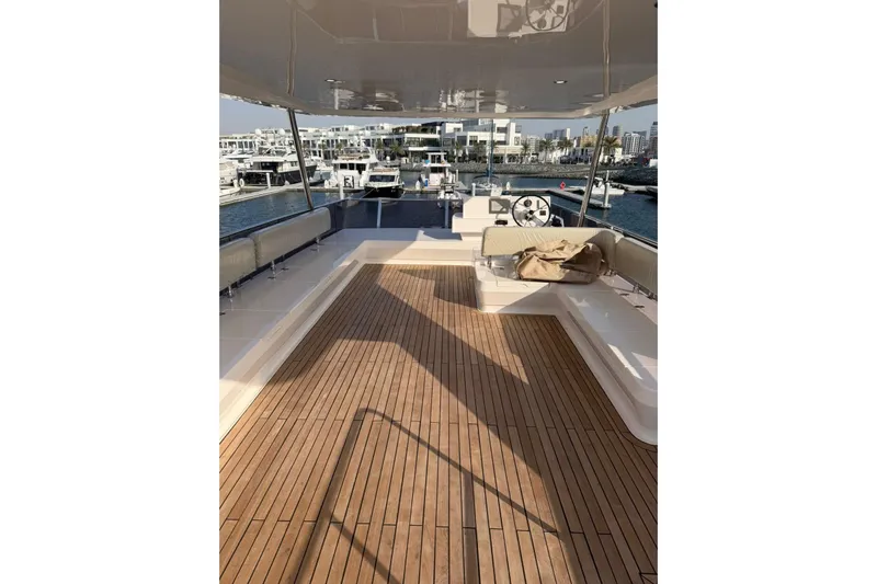  Yacht Photos Pics Luxurious 2025 Haiquan 62 yacht deck with wooden flooring and seating area.