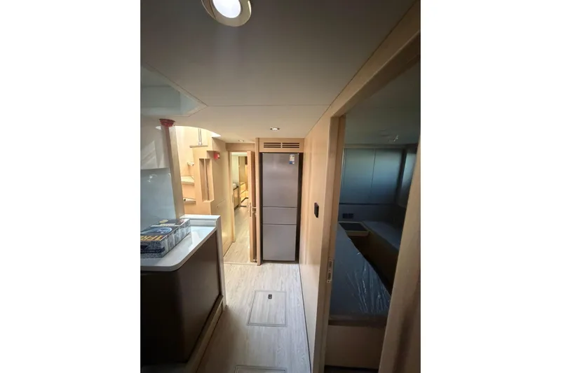  Yacht Photos Pics Interior of 2025 Haiquan 62 yacht, featuring modern kitchen and hallway design.