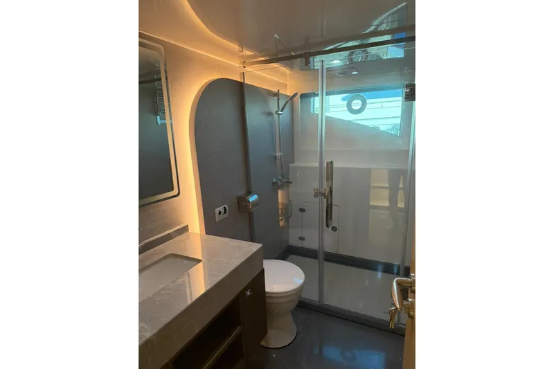  Yacht Photos Pics Modern bathroom in 2025 Haiquan 62 yacht with glass shower and sleek design.