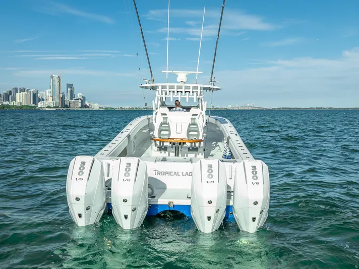  Yacht Photos Pics Freeman 37 boat, 2021 model, with four engines on open water near city skyline.