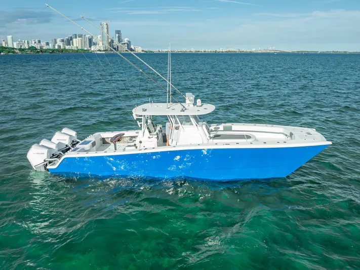  Yacht Photos Pics 2021 Freeman 37 boat on blue ocean with city skyline in background.