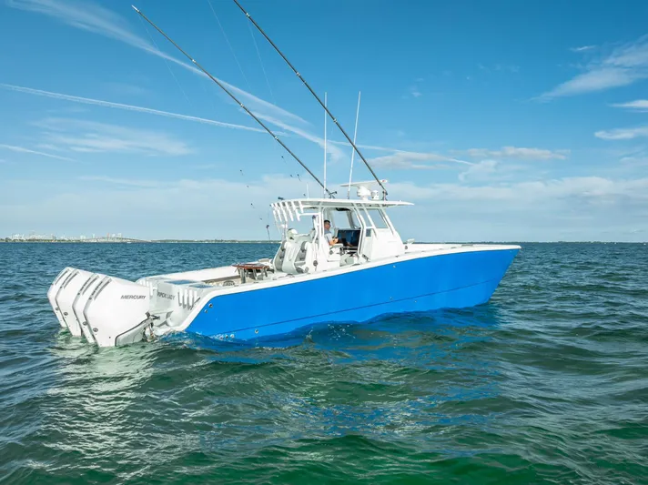  Yacht Photos Pics 2021 Freeman 37 boat on open water, featuring a sleek blue hull and twin engines.