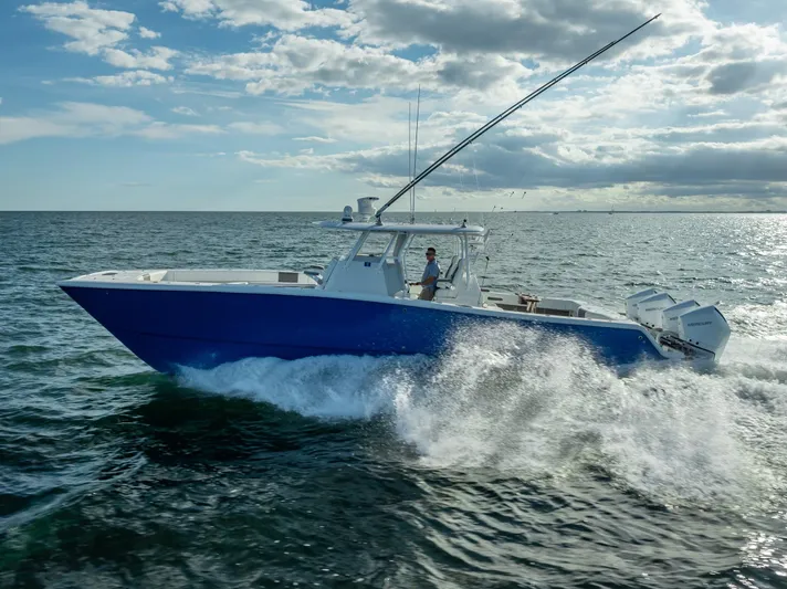  Yacht Photos Pics Freeman 37 boat cruising on open water, 2021 model, under a partly cloudy sky.