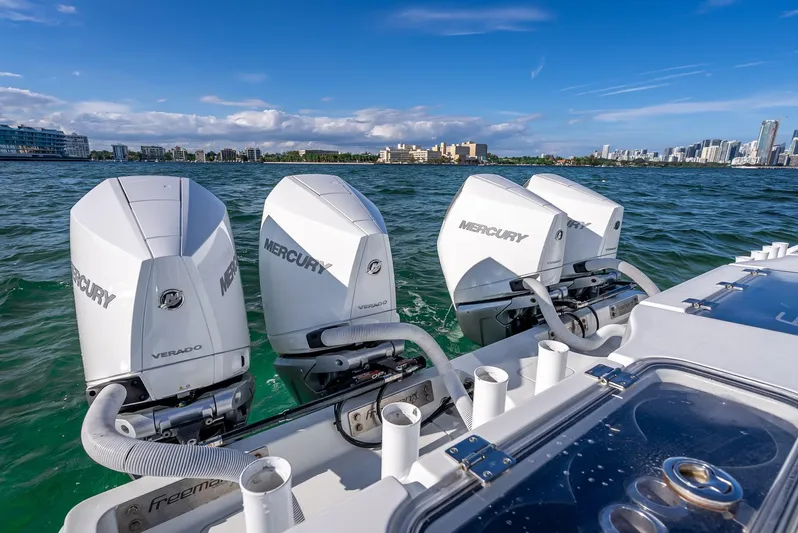  Yacht Photos Pics Triple Mercury outboard engines on a 2021 Freeman 37 boat in scenic waters.