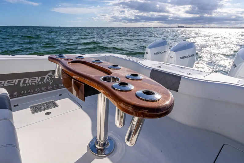  Yacht Photos Pics Freeman 37 boat, 2021 model, with wooden fishing rod holder, ocean backdrop.