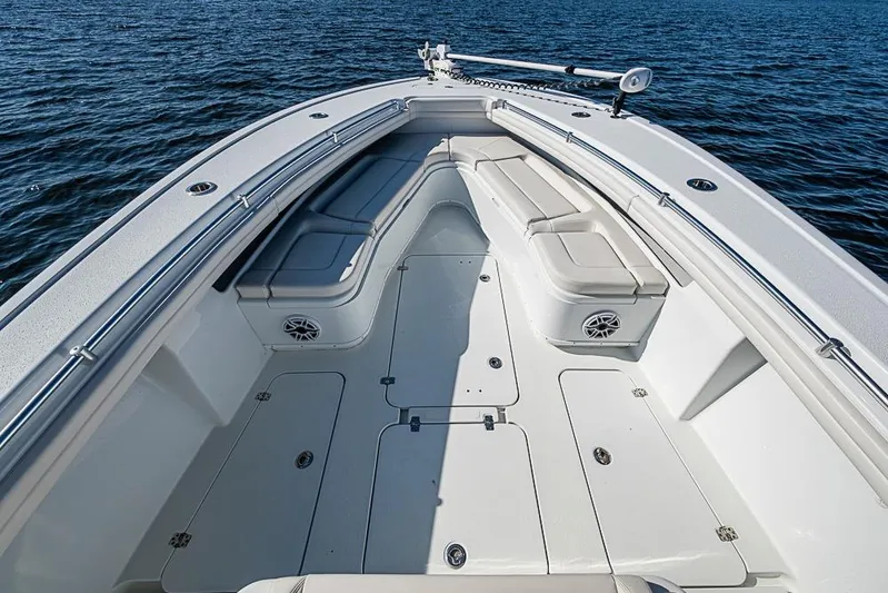  Yacht Photos Pics 2021 Yellowfin 32 Offshore boat interior with cushioned seating on calm water.