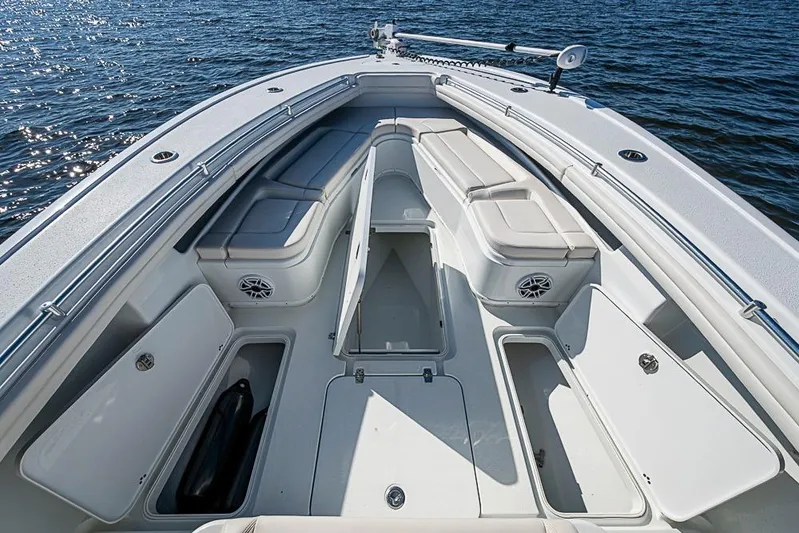  Yacht Photos Pics 2021 Yellowfin 32 Offshore boat interior with open storage compartments on calm water.