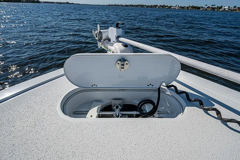  Yacht Photos Pics 2021 Yellowfin 32 Offshore boat with open anchor hatch on calm water.