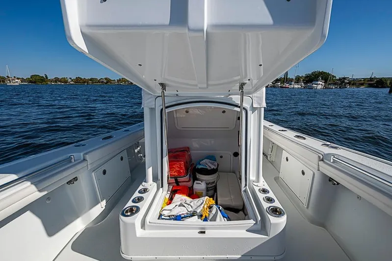  Yacht Photos Pics 2021 Yellowfin 32 Offshore boat with open storage compartment on a sunny day.