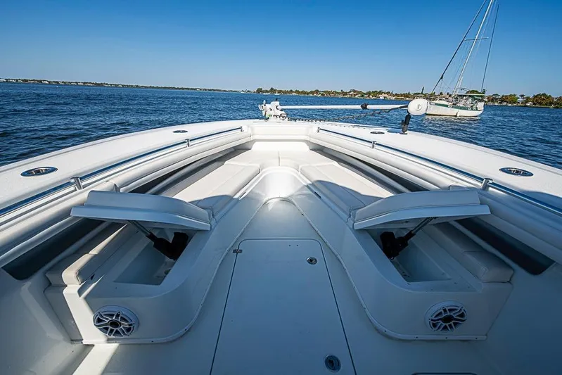  Yacht Photos Pics 2021 Yellowfin 32 Offshore boat interior with open seating, on calm water.
