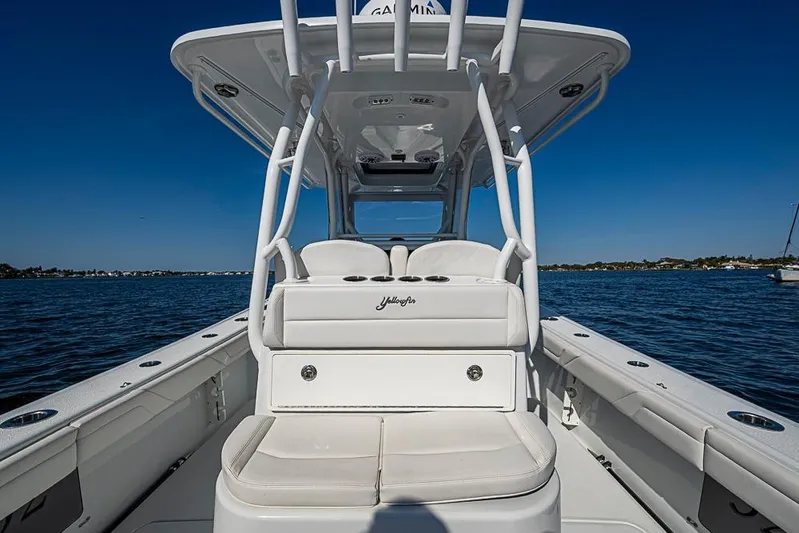  Yacht Photos Pics 2021 Yellowfin 32 Offshore boat interior with white seating, on calm blue water.