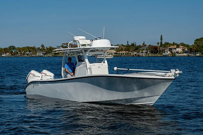  Yacht Photos Pics 2021 Yellowfin 32 Offshore boat cruising on a sunny day with twin engines.