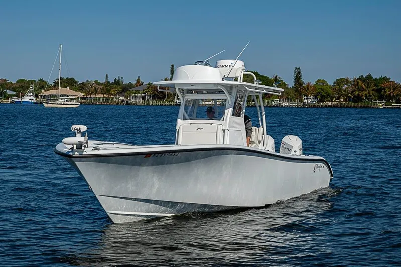  Yacht Photos Pics 2021 Yellowfin 32 Offshore boat cruising on a sunny day in a scenic waterway.