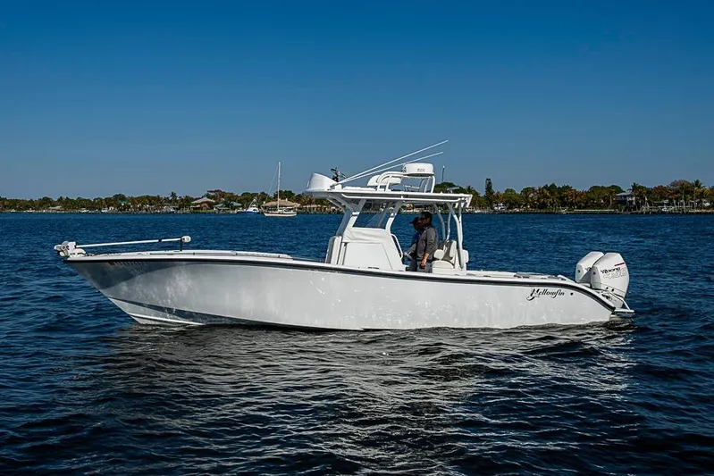  Yacht Photos Pics 2021 Yellowfin 32 Offshore boat on calm water under clear blue sky.