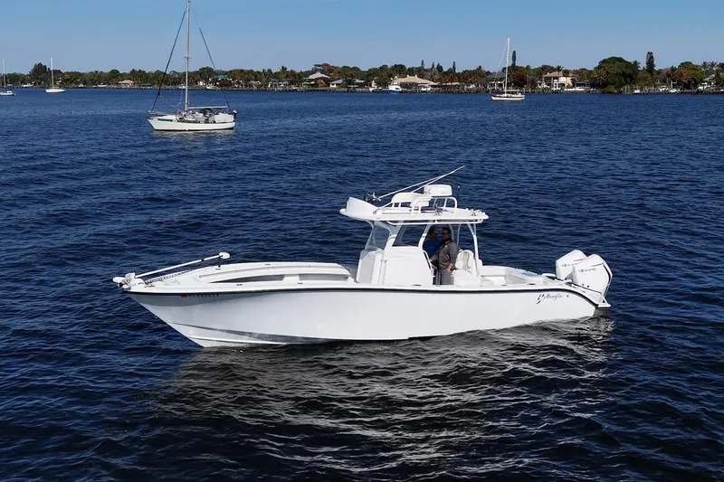  Yacht Photos Pics 2021 Yellowfin 32 Offshore boat cruising on a calm blue sea.