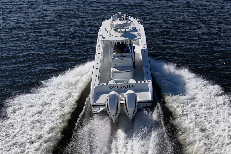  Yacht Photos Pics 2021 Yellowfin 32 Offshore boat cruising on open water, rear view.