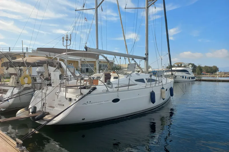  Yacht Photos Pics Sailboat Elan Impression 434, 2005 model, docked in a marina under a clear blue sky.