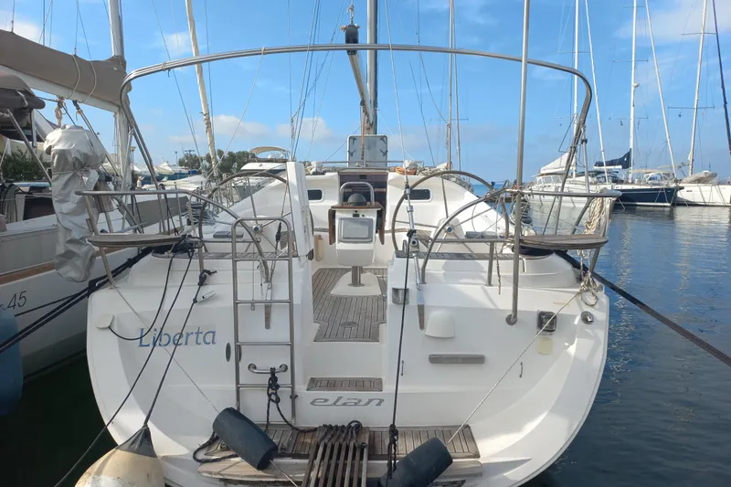  Yacht Photos Pics 2005 Elan Impression 434 sailboat docked in marina, rear view with clear sky.