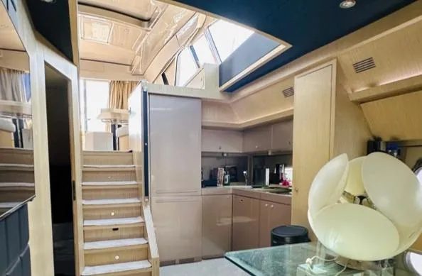  Yacht Photos Pics Luxurious interior of a 2006 Riva 68 Ego yacht with modern kitchen and elegant design.