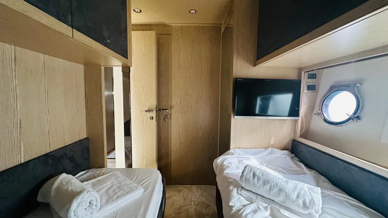  Yacht Photos Pics Luxurious cabin interior of 2006 Riva 68 Ego yacht with twin beds and TV.