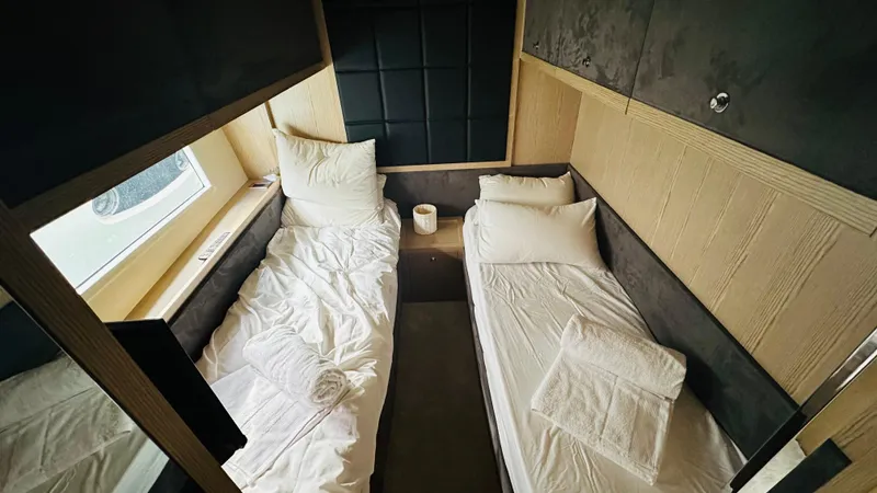  Yacht Photos Pics Twin cabin interior of 2006 Riva 68 Ego yacht with modern design and cozy bedding.