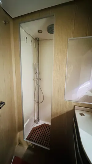  Yacht Photos Pics Shower area in 2006 Riva 68 Ego yacht with modern fixtures and wooden accents.