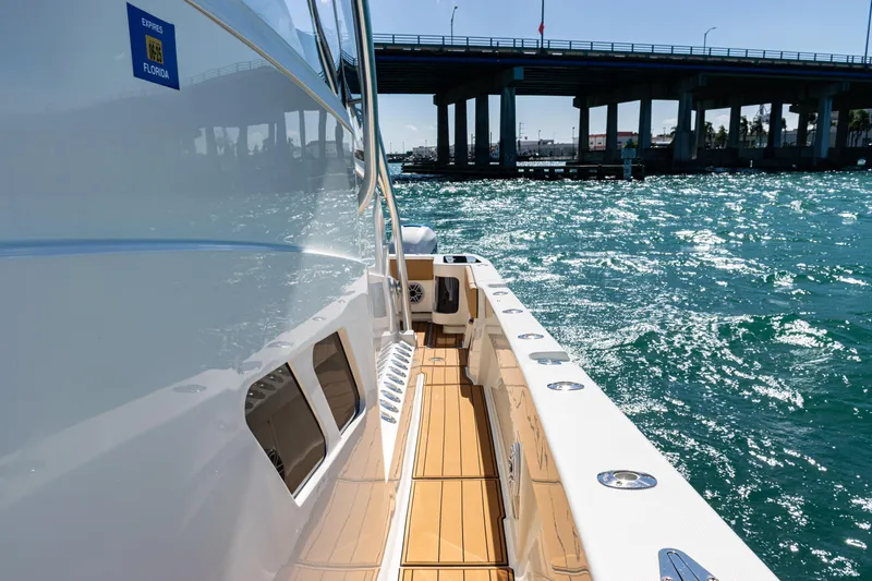  Yacht Photos Pics 2016 SeaVee 430 boat cruising under a bridge on sparkling blue water.