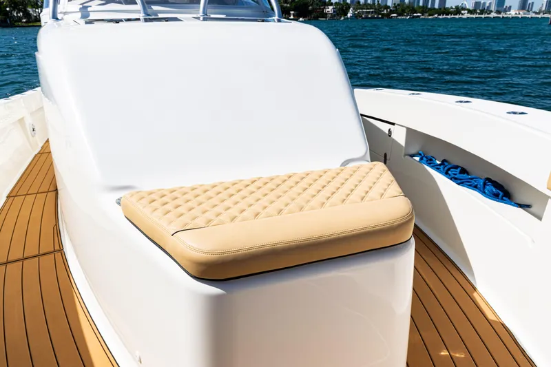  Yacht Photos Pics 2016 SeaVee 430 boat with cushioned seating and teak deck, docked on calm water.