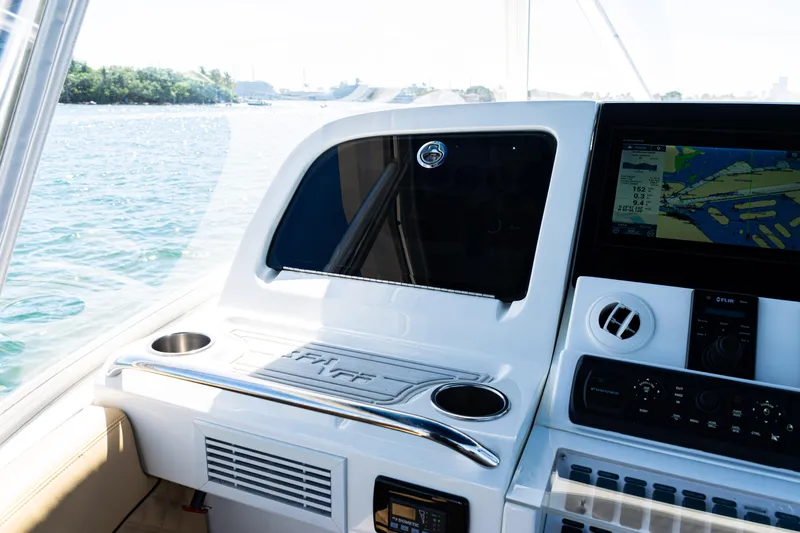  Yacht Photos Pics 2016 SeaVee 430 boat dashboard with navigation screen and cup holders, overlooking water.