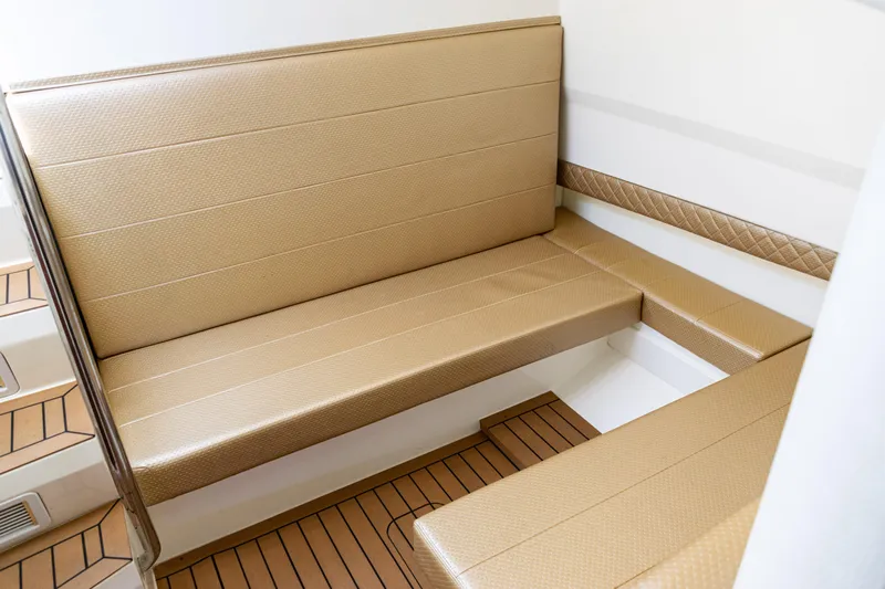  Yacht Photos Pics Luxurious seating area on 2016 SeaVee 430 boat with tan upholstery and wood flooring.