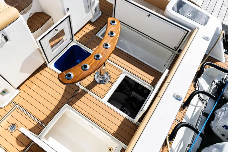  Yacht Photos Pics 2016 SeaVee 430 boat deck with storage compartments and rod holders.