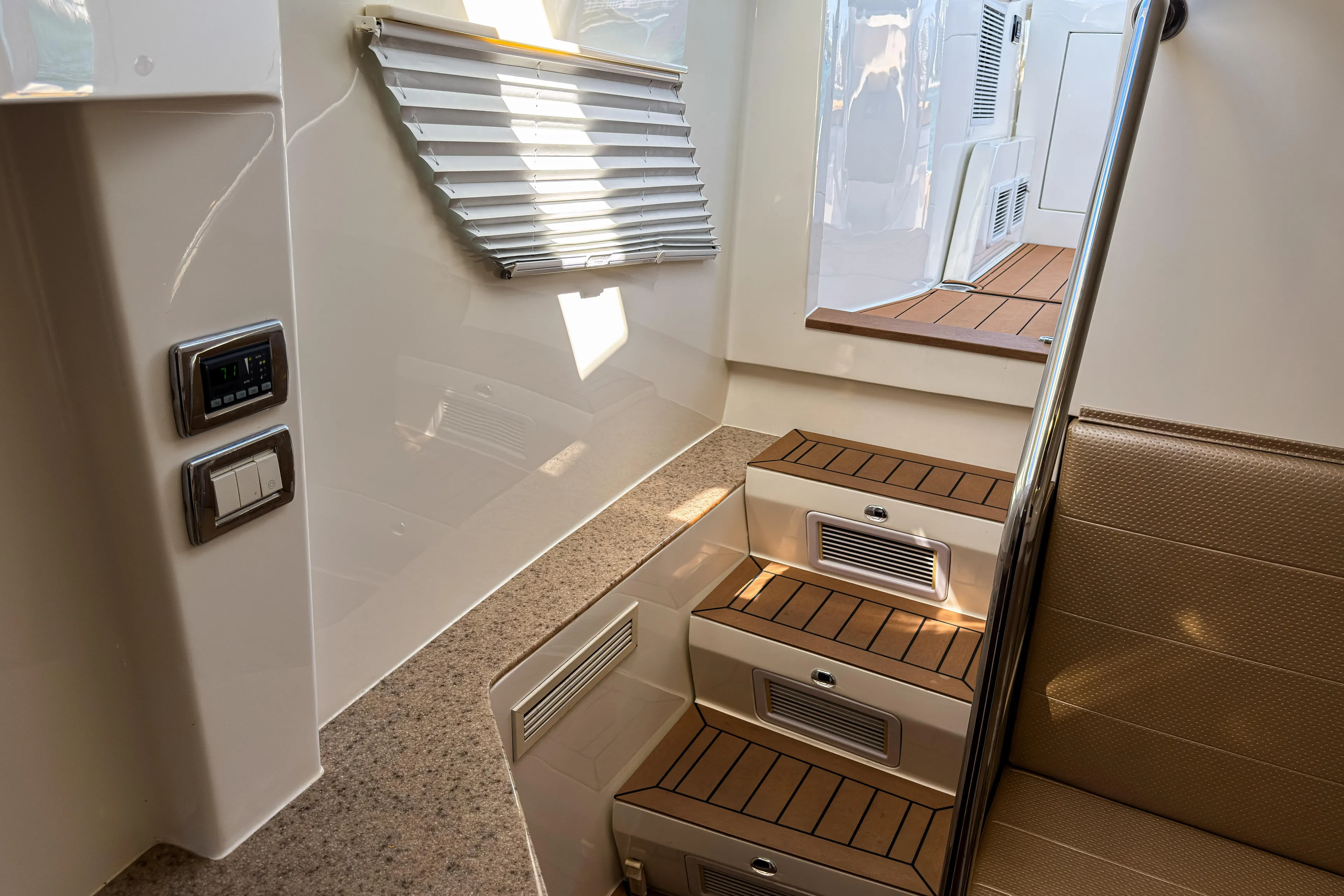  Yacht Photos Pics Interior of 2016 SeaVee 430 boat with wooden steps and modern controls.