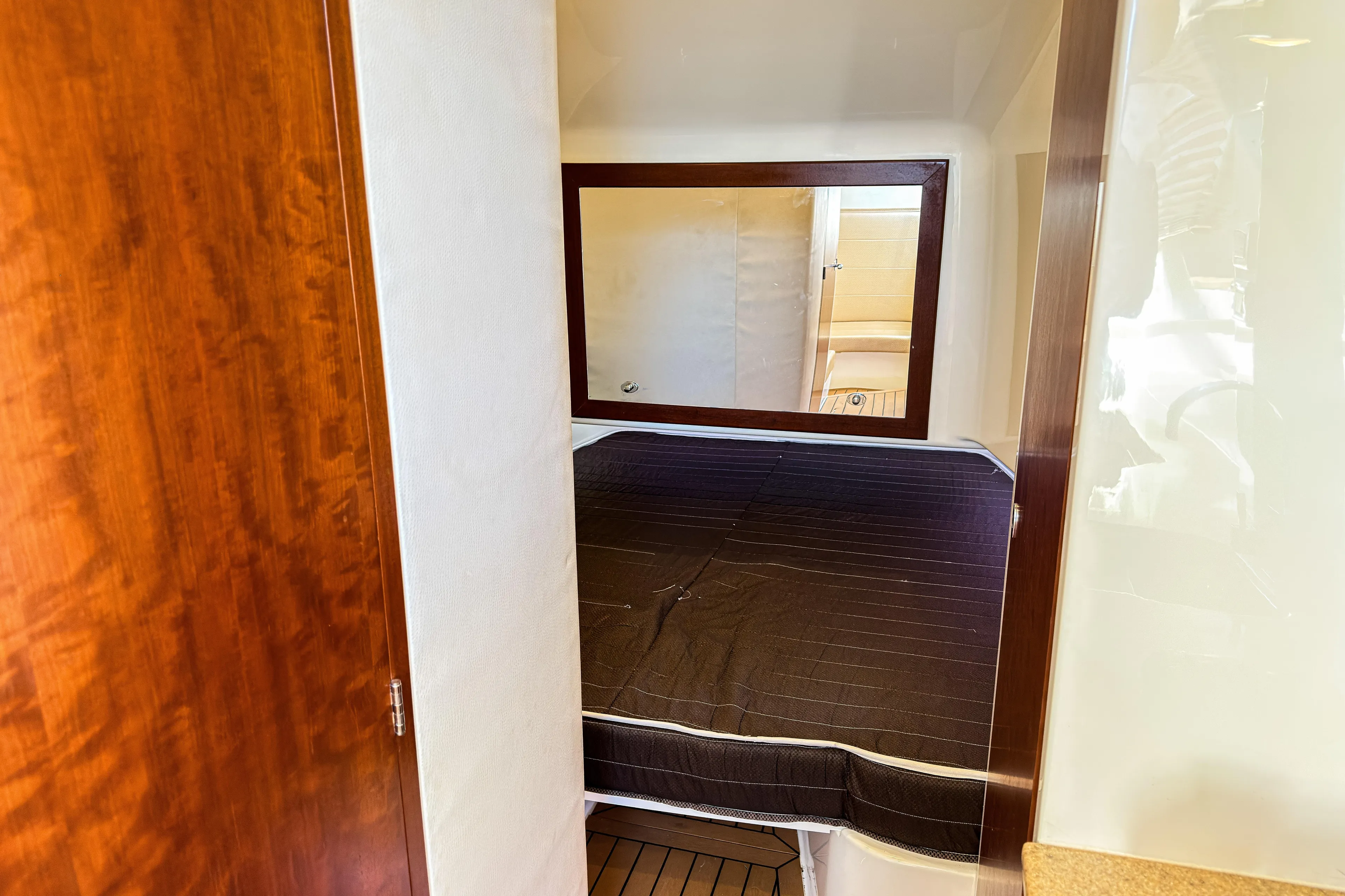  Yacht Photos Pics 2016 SeaVee 430 cabin interior with bed, wooden accents, and mirror.
