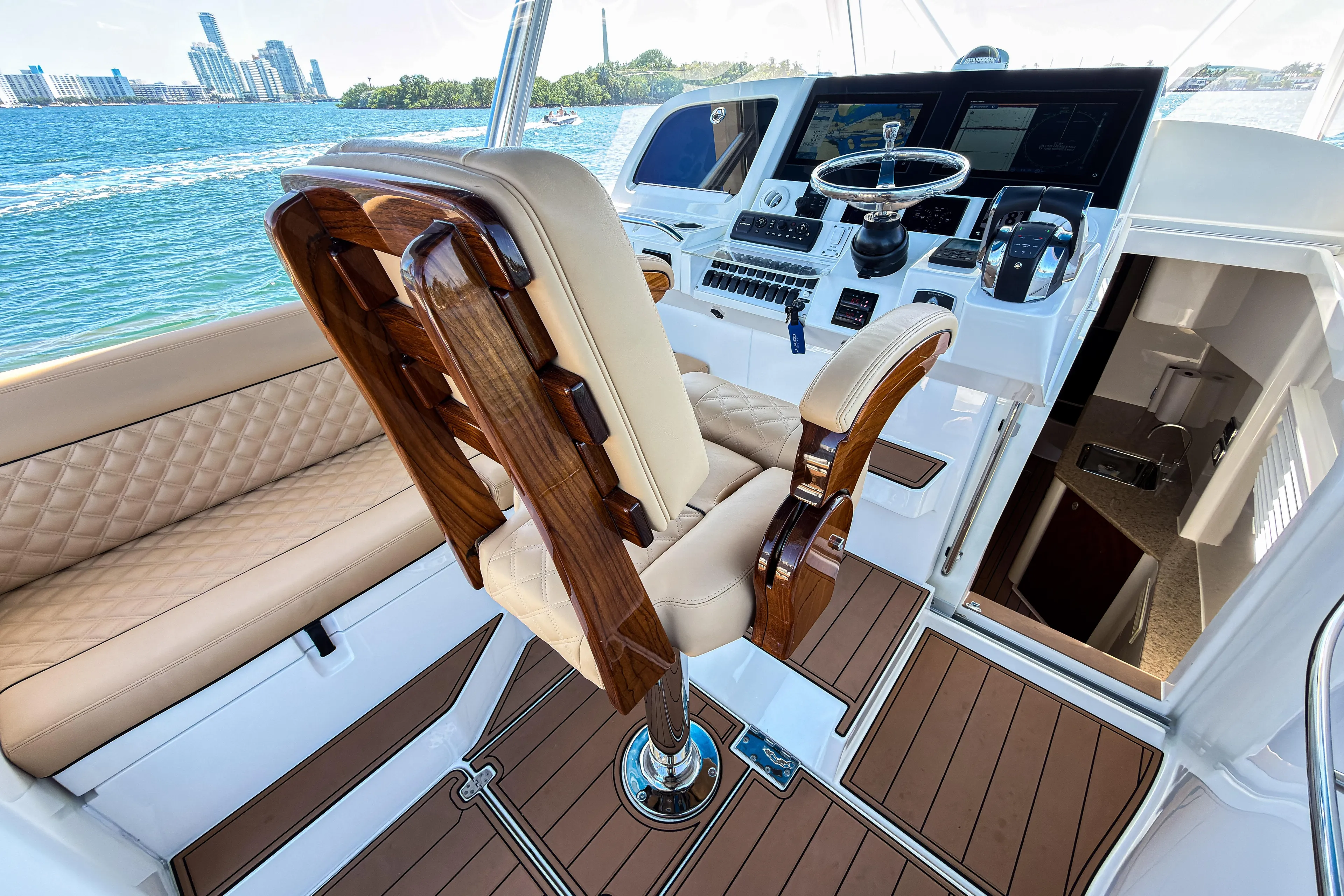  Yacht Photos Pics Luxurious 2016 SeaVee 430 yacht interior with elegant helm and seating, overlooking scenic waterfront.