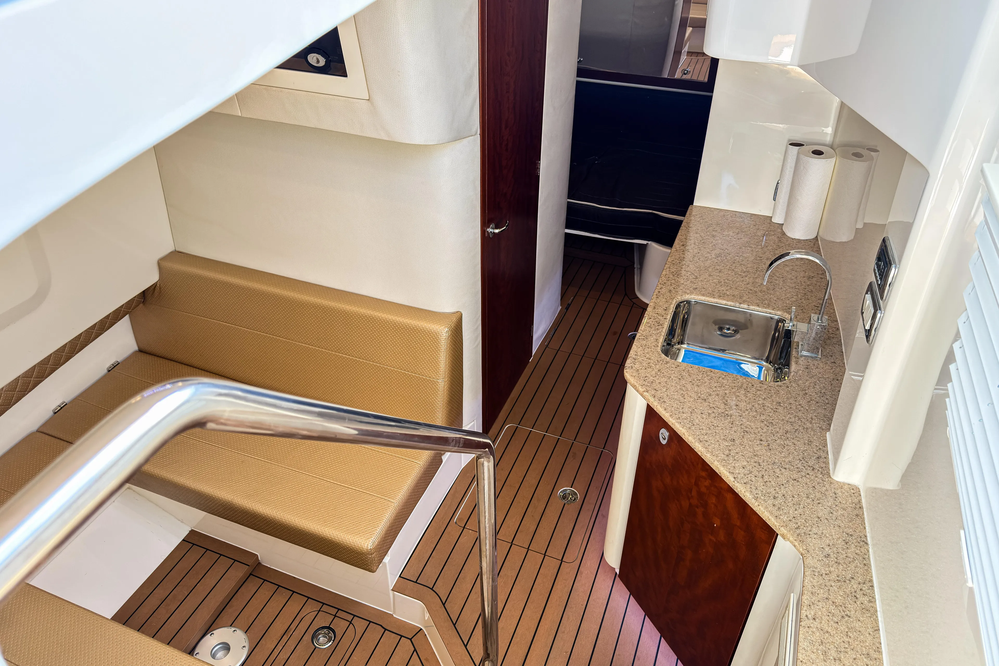  Yacht Photos Pics Interior of 2016 SeaVee 430 boat with kitchenette and seating area.