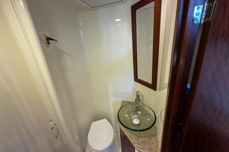  Yacht Photos Pics Compact bathroom in 2016 SeaVee 430 boat with modern sink and toilet.