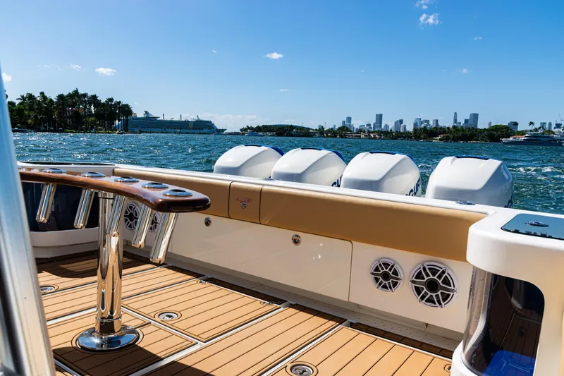  Yacht Photos Pics 2016 SeaVee 430 boat with powerful engines, cruising near a city skyline on a sunny day.