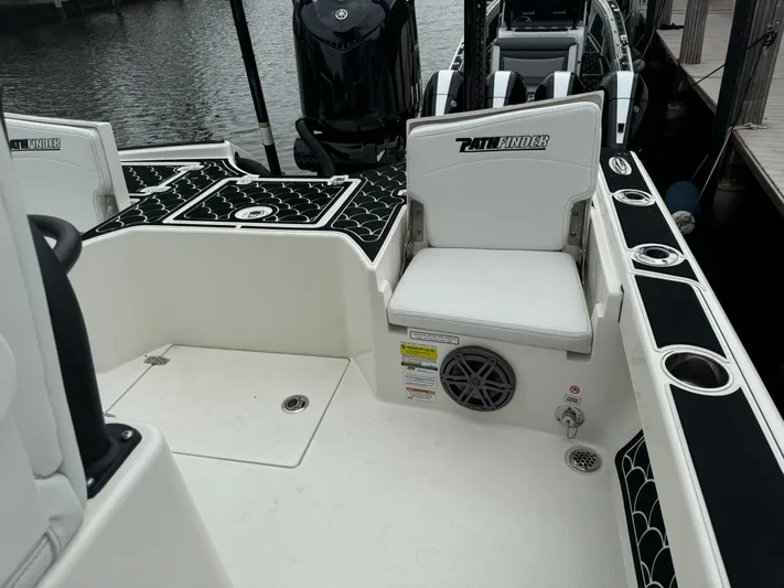 Yacht Photos Pics 2024 Pathfinder 2500 Hybrid boat interior with seating and storage compartments.