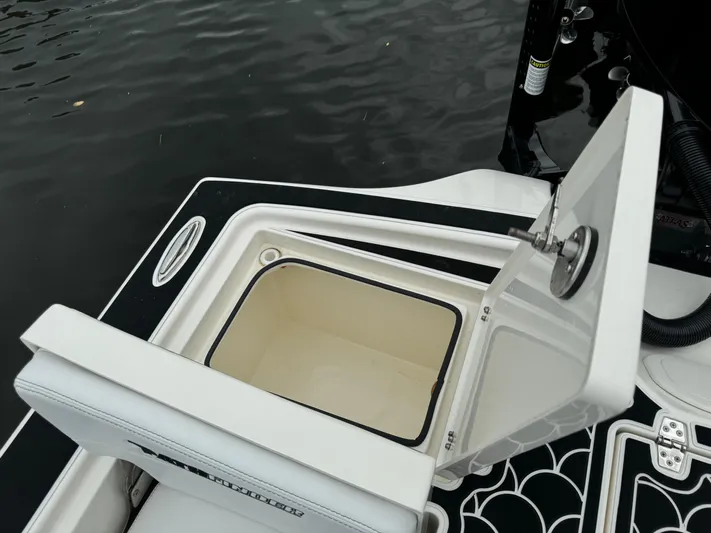  Yacht Photos Pics Open storage compartment on 2024 Pathfinder 2500 Hybrid boat by the water.