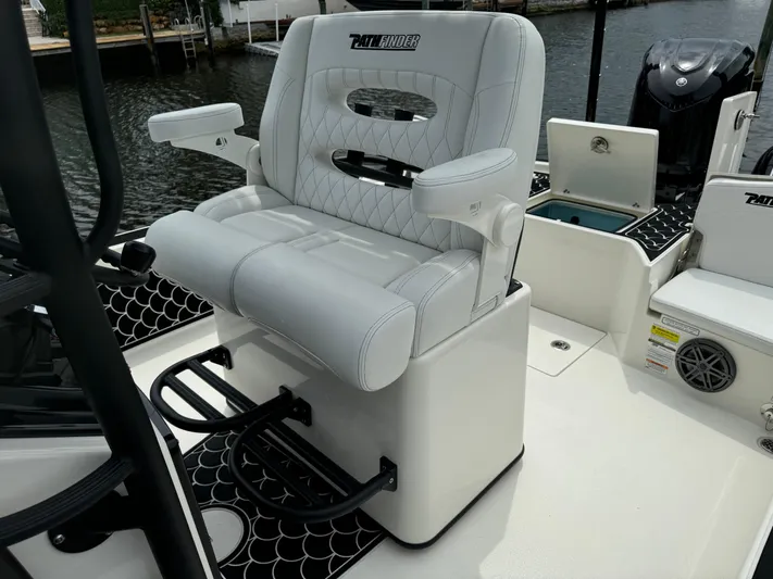  Yacht Photos Pics 2024 Pathfinder 2500 Hybrid boat seat with armrests and footrests, dockside view.