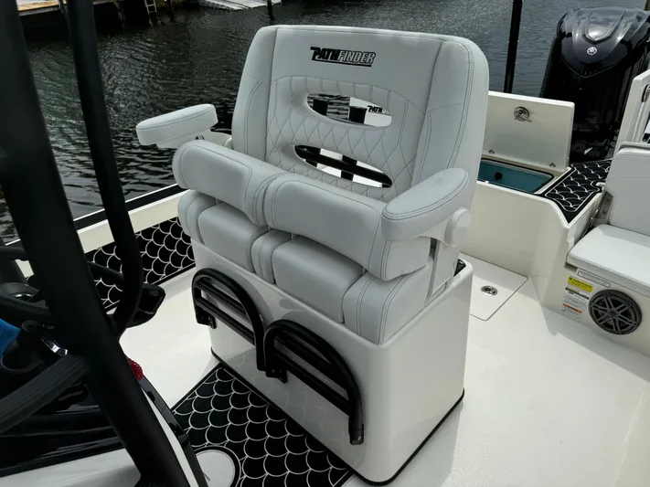  Yacht Photos Pics 2024 Pathfinder 2500 Hybrid boat seat with armrests and storage, docked by the water.