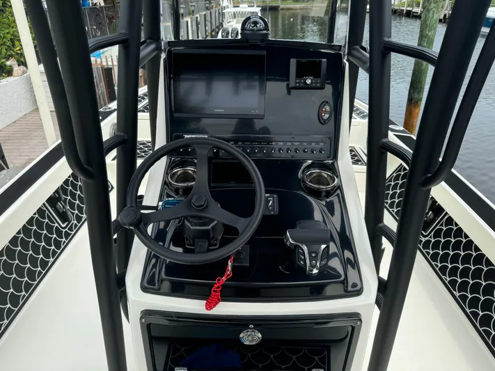  Yacht Photos Pics 2024 Pathfinder 2500 Hybrid boat console with steering wheel and controls.