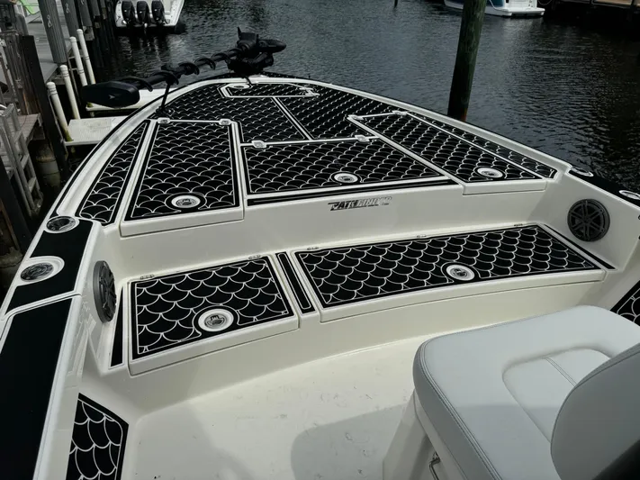  Yacht Photos Pics 2024 Pathfinder 2500 Hybrid boat with stylish black and white deck design.