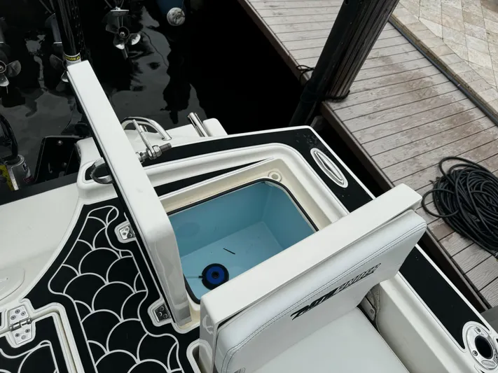  Yacht Photos Pics 2024 Pathfinder 2500 Hybrid boat with open storage compartment at dock.