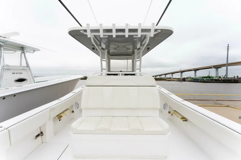  Yacht Photos Pics 2019 Invincible 39 Open Fisherman boat with white seating and T-top, docked near a bridge.