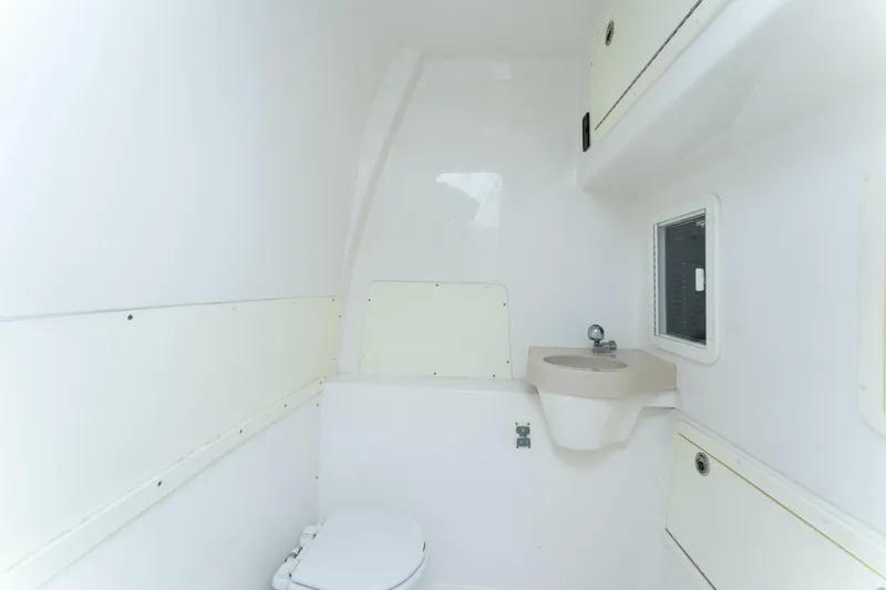  Yacht Photos Pics 2019 Invincible 39 Open Fisherman boat bathroom with toilet and sink.