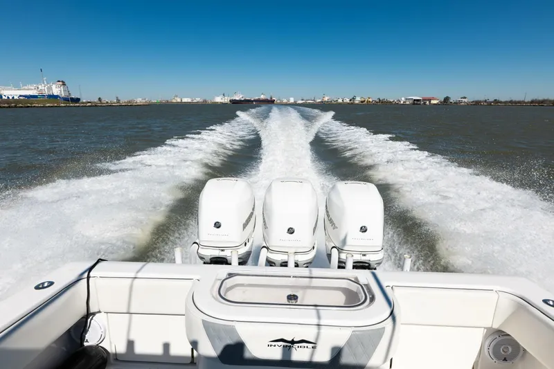 Yacht Photos Pics 2019 Invincible 39 Open Fisherman boat with triple engines cruising on open water.